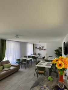 a living room with tables and couches and chairs at Casa Osan in Tăşnad