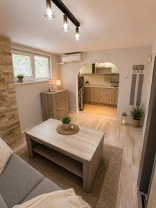 a living room with a table and a kitchen at Catherdral Apartments with Parking in Varna City