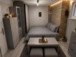 a small bedroom with a bed and a table at Catherdral Apartments with Parking in Varna City