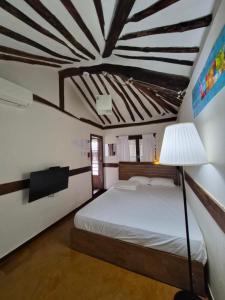a bedroom with a bed and a lamp in it at Gohyundang in Jeonju