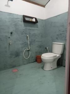 a bathroom with a toilet and a shower at Ceylon Bay in Arugam Bay