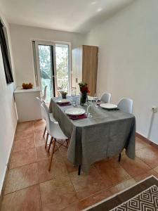 a dining room with a table with white chairs and a tableablish at Reževići apartment Lav in Reževići