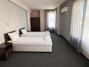 a hotel room with two beds and a window at Hotel Alexander in Sofia +18 photos