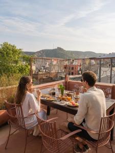 a group of people sitting around a table on a balcony at Cozy Den in Jaipur