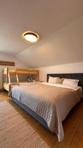 a bedroom with a large bed in a room at Family Nest Băișoara - Confort Premium, Wi-Fi rapid, ciubăr la cerere și view spectaculos in Muntele Băişorii