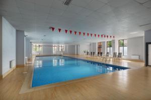 a large swimming pool in a large room at Ani Grand Hotel Yerevan in Yerevan