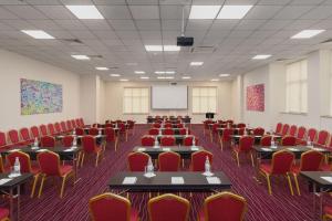 a conference room with tables and chairs and a whiteboard at Ani Grand Hotel Yerevan in Yerevan +83 photos