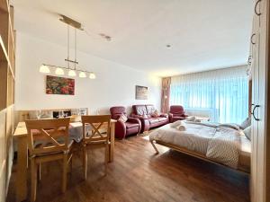 a living room with a bed and a dining room at Rubiblick, Montana Haus in Oberstdorf +22 photos