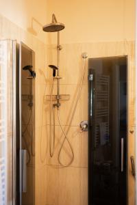 a bathroom with a shower with a shower head at Casamare Hotel in San Vincenzo +74 photos