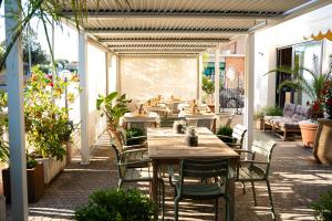 a row of tables and chairs on a patio at Casamare Hotel in San Vincenzo