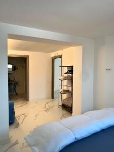 a bedroom with a bed and a room with a wall at Villa Olimpia in Civitavecchia