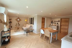 a kitchen and dining room with a table and chairs at Le jardin de Nigelle , En Provence in Mallemoisson