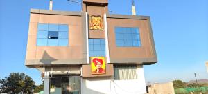 a building with two posters on the side of it at Hotel ram priya in Chhatarpur