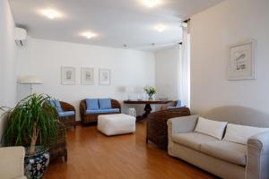 a living room with a couch and chairs and a table at Hotel Telenia in Lido di Jesolo +82 photos