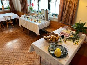 a room with two tables with food on them at Ferienhof Stanzl in Rappottenstein +51 photos