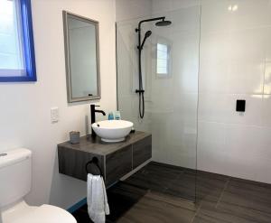 a bathroom with a sink and a shower at Kuki Kainga in Matavera +23 photos