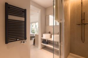 a bathroom with a sink and a glass shower door at Suite 33 - Boutique Apartments in San Benedetto del Tronto +111 photos