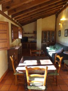 ein Wohnzimmer mit einem Tisch und einem Sofa in der Unterkunft La Fragua de los Alvaro 2 in Turégano