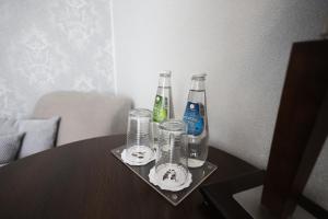 a table with two bottles and glasses on it at Aviator Hotel in Radom