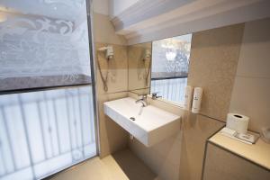 a bathroom with a sink and a mirror at Aviator Hotel in Radom +34 photos