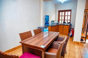 a kitchen with a wooden table and chairs at Tashi Pal Hotel Pvt. Ltd in Kathmandu