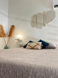 a bedroom with a large bed with pillows on it at Azuri Lodge Piscine Privée Marina Golf in Saint-François
