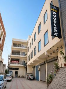 a building with a sign on the side of it at The WoodLuck Zirakpur Chandigarh - Sidham Group of Hotels in Chandīgarh