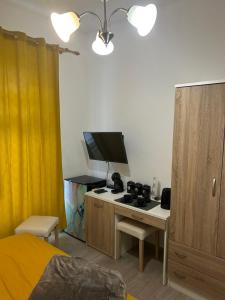 a bedroom with a bed and a desk with a television at Rooms Marija in Malinska