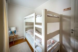 a bedroom with two bunk beds and a table at Hanko Sailor House in Hanko +9 photos