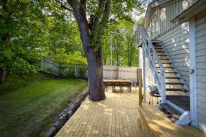 a wooden deck with a table and a tree at Hanko Sailor House in Hanko