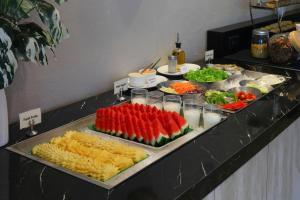 a buffet with many different types of fruits and vegetables at C & N Hotel Patong, Phuket in Patong Beach