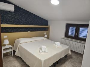 a bedroom with two beds with towels on them at B&B Sant'Anna in Lercara Friddi