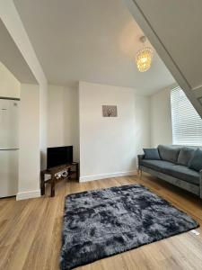 a living room with a couch and a television at Spacious Two Bed House With Stunning View. in Paull