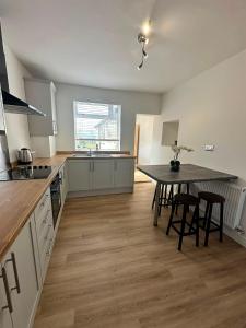 a large kitchen with a table and chairs in it at Spacious Two Bed House With Stunning View. in Paull