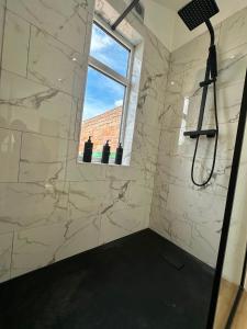 a bathroom with a shower and a window at Spacious Two Bed House With Stunning View. in Paull +31 photos