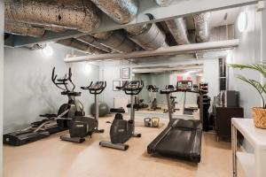 a gym with treadmills and ellipticals in a room at 2Home Hotel Apartments in Solna