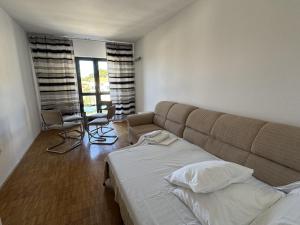 a bedroom with a couch and a table and chairs at Retro Apartment with Sea View in Podgora