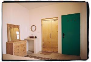 a bathroom with a green door and a sink at Dar Al-Andalus in Tamraght Ouzdar +105 photos