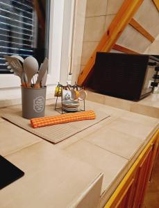 a counter with a tray of kitchen utensils on it at Chalet Etna dreamers in Nicolosi