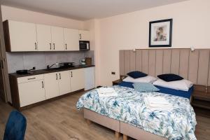 a bedroom with two beds and a kitchen at Agroturystyka Przy Wodospadzie in Lubrza