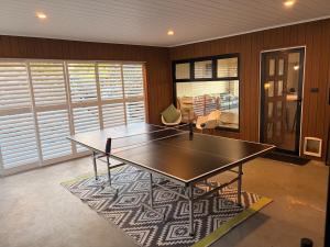 a ping pong table in a room with a bedroom at The Panorama On Earl in Albany