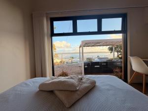 a bedroom with a bed with a view of the beach at The Panorama On Earl in Albany