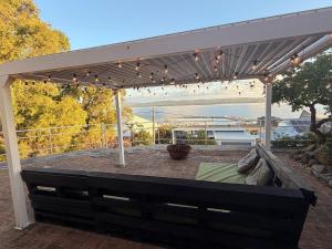 a white pergola with a couch under it at The Panorama On Earl in Albany