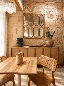 a dining room with a wooden table and chairs at Pètra Boutique Home by Symphonya Luxury Holiday Rentals in Scorrano