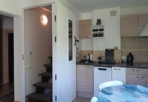 a kitchen with a stairway leading into a room at Lazdas in Saulkrasti +24 photos