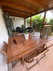 a wooden table and chairs on a patio at Rifugio Sereno in Taranto +72 photos