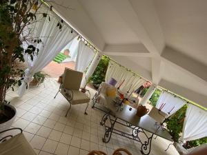 a living room with white curtains and a table and chairs at Rifugio Sereno in Taranto