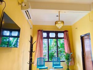 a dining room with a table and chairs and a window at Mon Aashray Stay in Guwahati