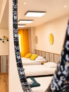 a room with two beds and a mirror at Hotel Le Florian in Cannes