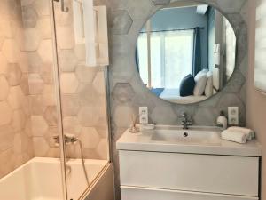 a bathroom with a sink and a mirror at Villa Privée - Les Trois J - Charme & Bien-être in Grimaud +7 photos